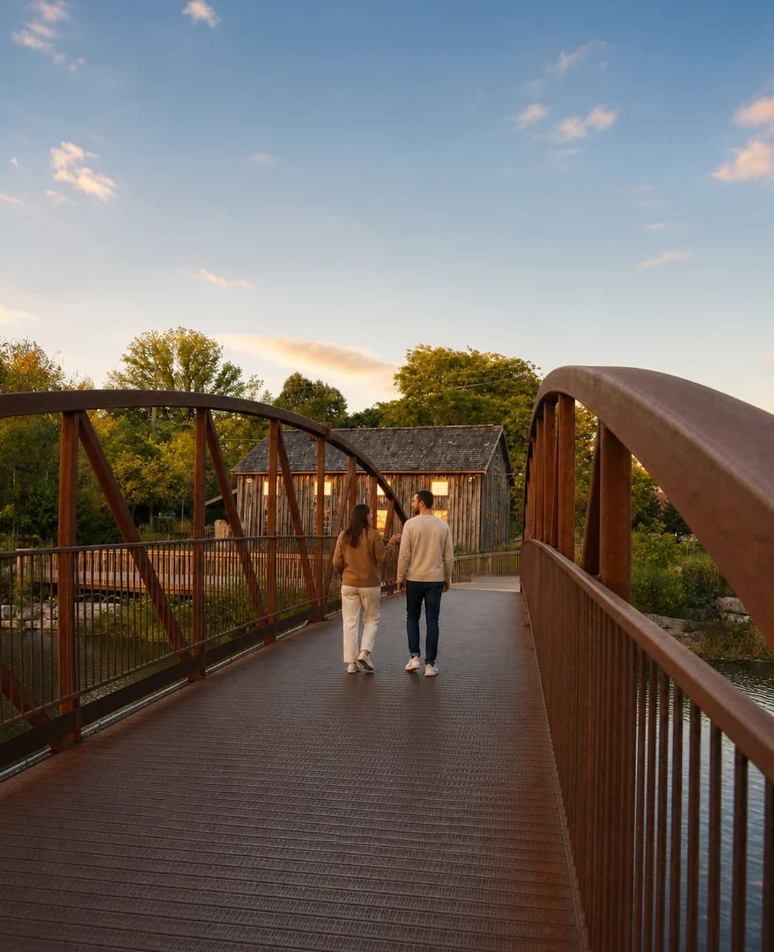 Two people walking and talking on a bridge in Waterloo